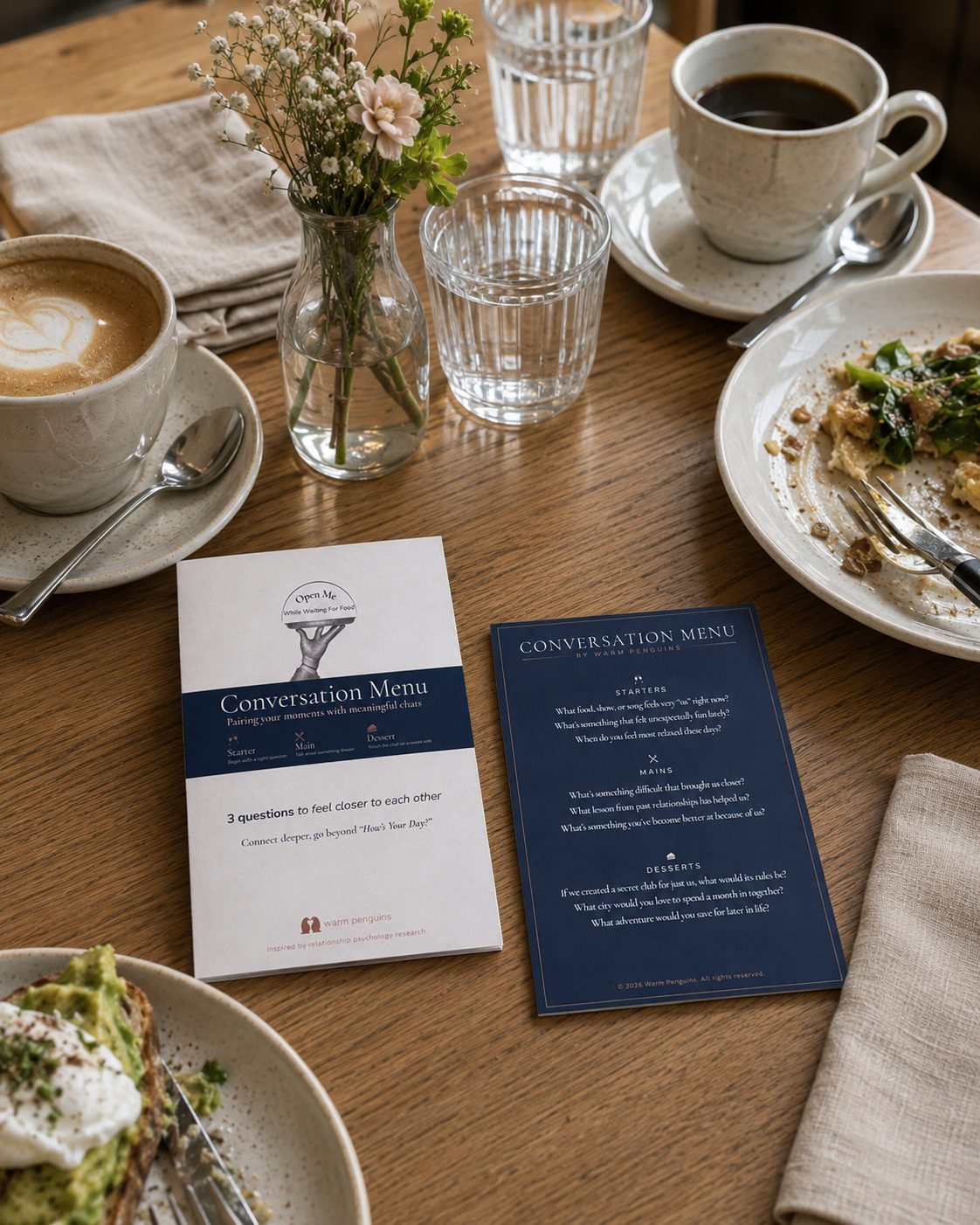 The Conversation Menu card on a café table, next to coffee and breakfast